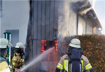 Mit einer Kettensäge schnitt die Feuerwehr zum Löschen ein Loch in die Wand.
