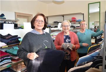 Monika Paulsen, Anke Schnaars und Marita Schilling (von links) hängen die neue Kleidung auf.