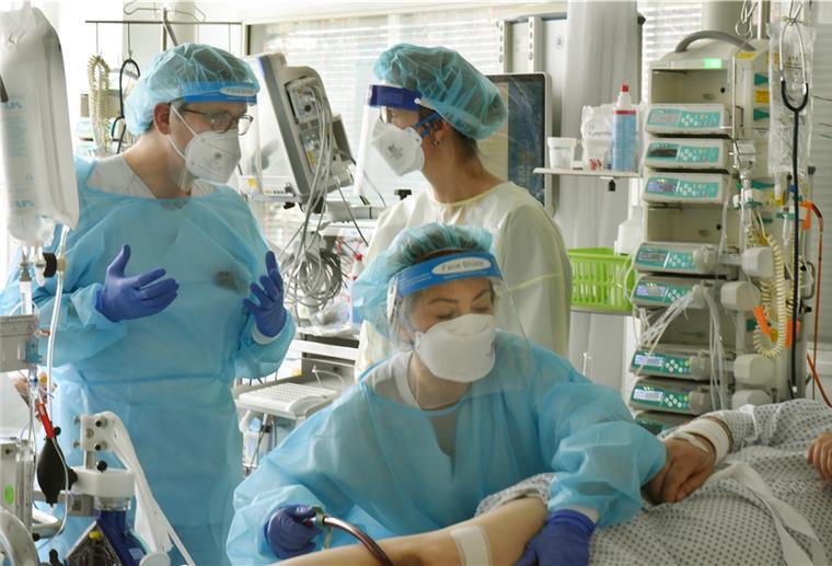 RKI sieht dramatische Situation in Kliniken Auf der Covid-19-Station, einem Bereich der Operativen Intensivstation vom Universitätsklinikum Leipzig, stehen der Leiter der Klinik, Prof. Dr. Sebastian Stehr (l) mit der Leitenden Bereichsleitung Sylvia Köppen (r) am Bett eines schwerkranken Patienten.