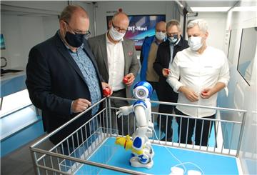 Nach kurzer Programmierung ist der humanoide Roboter auf dem Weg, Geestlands Bürgermeister Thorstern Krüger (links) den Stoffbären in die Hand zu drücken. 