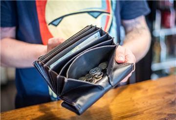 Im Bild: "Motato"-Restaurantinhaber Gregor Lewicki öffnet seine Trinkgeldbörse und erklärt, das vor allem die bargeldlose Zahlung während der vergangenen Monate in seinem Laden zugenommen habe.