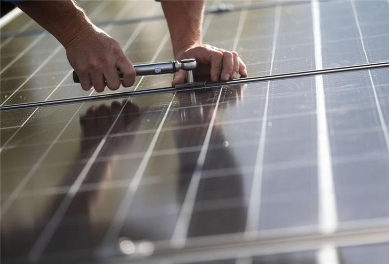 Photovoltaikförderung Bremerhaven: Zwischenbilanz nach zwei Monaten Mitarbeiter einer Firma montieren Photovoltaikmodule