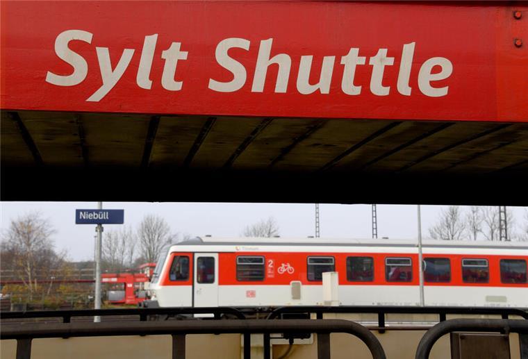 Ein Wagen des Autozuges Syltshuttle und ein Nahverkehrszug sind zu sehen.