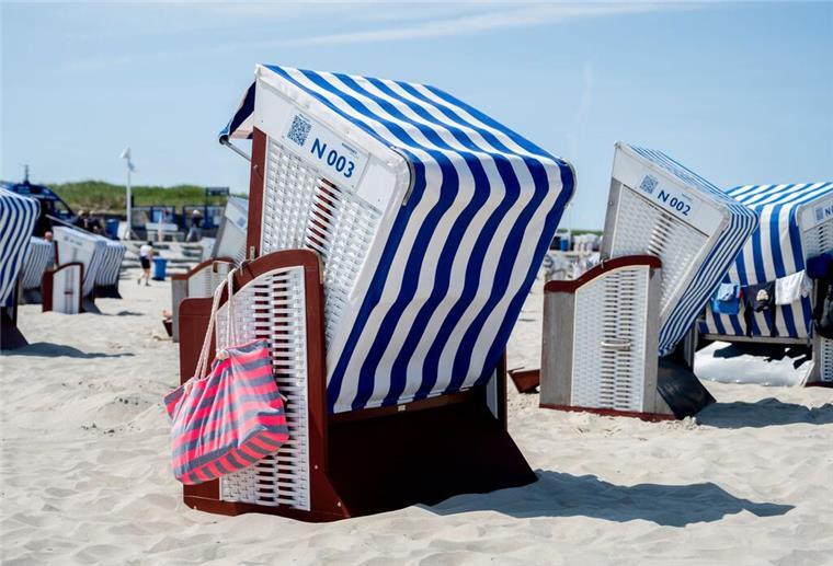  Eine Strandtasche hängt bei sonnigem Wetter an einem Strandkorb am Nordstrand der Insel. 
