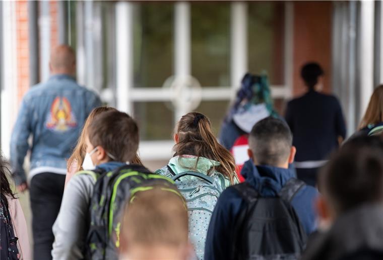 Schülerinnen und Schüler gehen zum Klassenzimmer.