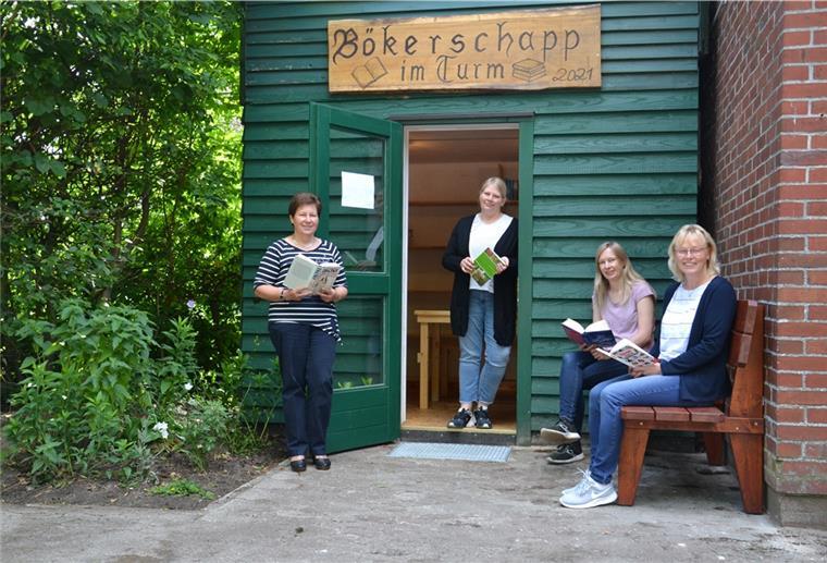 Glinstedt schmökert im Bökerschapp Vier Frauen mit Büchern in der Hand stehen vor einem ehemaligen Schlauchturm
