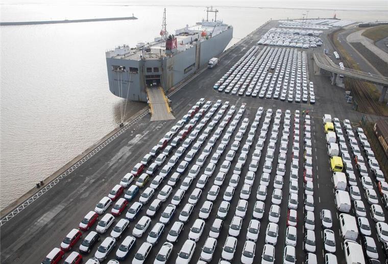 Der Hafen in Emden mit Autoumschlag. Zu sehen sind viele Autos und ein großer Autofrachter an der Kaje.