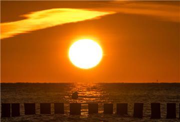 Sonne am Meer, Sonnenuntergang. Sonne, blauer Himmel und steigende Temperaturen: In Niedersachsen und im Land Bremen kündigt sich ein heißer Dienstag an – besonders im Landesinneren wird es sommerlich warm.