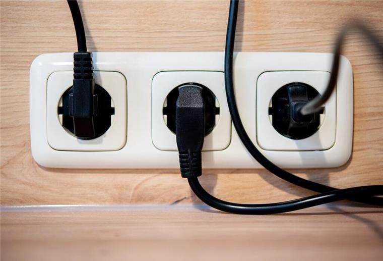 Neue Strom-Regel gilt ab Oktober 2025: So können Kunden profitieren Die Netzstecker mehrerer Küchengeräte stecken in einer Steckdose an einer Küchenzeile.