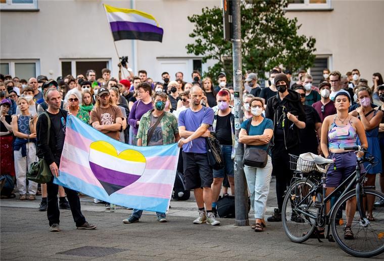Teilnehmerinnen und Teilnehmer einer Mahnwache kommen nach einem Angriff auf eine Transfrau in Bremen zusammen