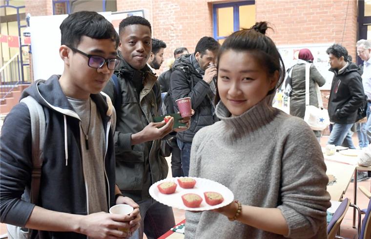 Erster China Day an der Hochschule Bremerhaven Tianyi Kang (rechts) aus Peking hält traditionelle chinesische Köstlichkeiten bereit, die am China Day an der Hochschule probiert werden konnten.