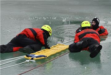 Übung im Watt'n Bad: In den Überlebensanzügen halten es die gespielten Unfallopfer einige Zeit im Eisloch aus, bis die Kollegen zur Rettung kommen.