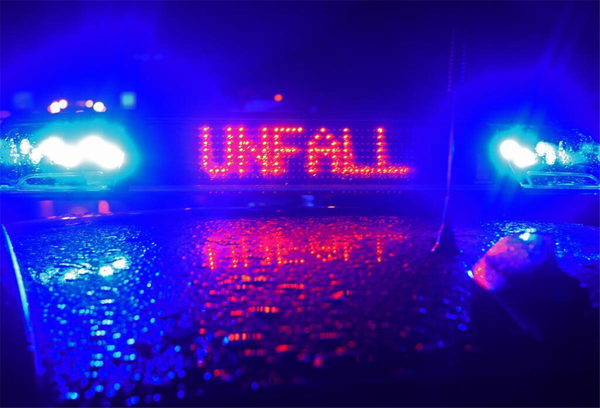"Unfall" in roten LED-Leuchtbuchstaben steht zwischen zwei Blaulichtern auf dem Dach eines Polizeiwagens.