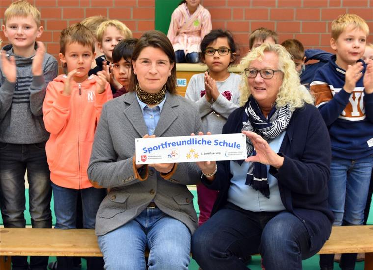 Unter dem Beifall der Schüler: Tanja Bladauski (vorne links) übergab als  Beauftragte für den Schulsport im Landkreis Rotenburg  das neue Schild an die kommissarische Schulleiterin Ilse Castens-Rillox.
