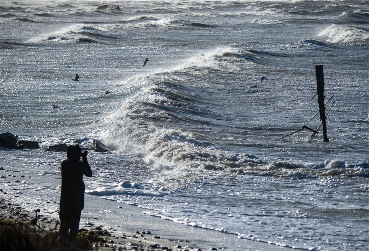 Nächster Sturm mit Sturmflut kommt auf den Norden zu Urlauber beobachten bei kräftigem Wind den Wellengang durch das Sturmtief "Nadia".