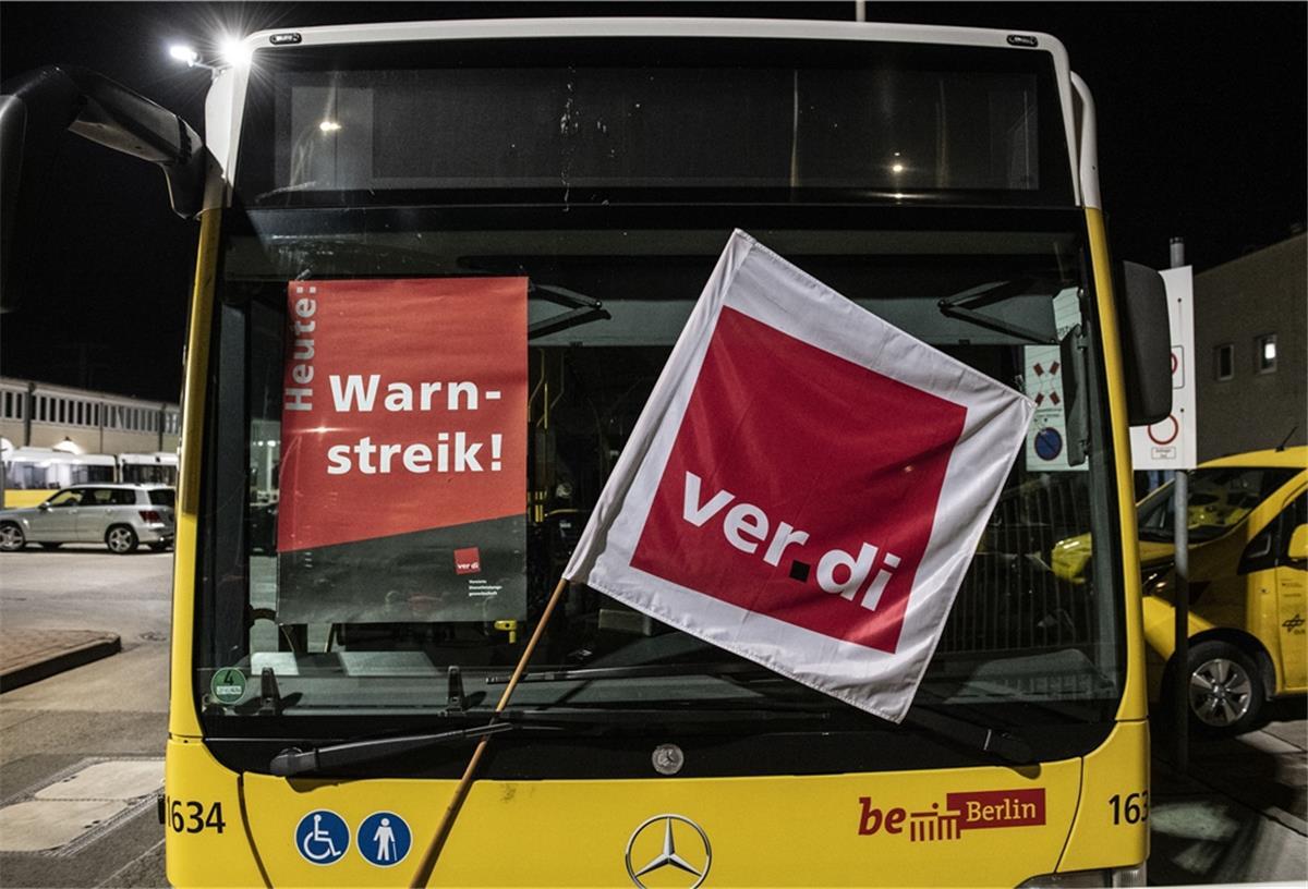 Bus mit Vorderansicht. Fahnen und Plakat in der Windschutzscheibe.