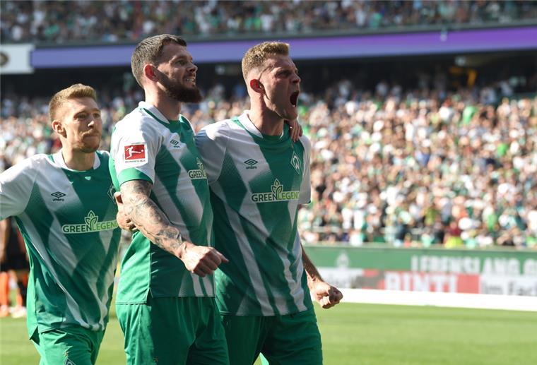 Werders Oliver Burke (M) jubelt in der Nachspielzeit, mit Marvin Ducksch (r) und Mitchell Weiser über sein Tor zum 2:2.