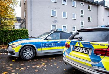 Zwei Polizeifahrzeuge stehen vor dem Mehrfamilienhaus, wo  eine 15-Jährige ihren dreijährigen Halbbruder in Detmold mit einem Messer getötet haben soll.  
