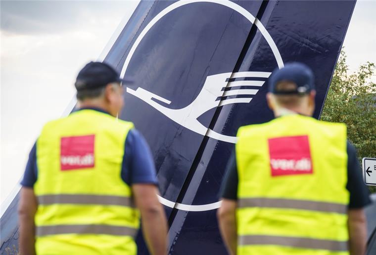 Zwei Verdi-Mitglieder stehen am Morgen am Frankfurter Flughafen am Eingang zur Lufthansa-Basis.